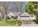 Charming home with a well-maintained front yard, garage, and manicured bushes at 11000 White Stag Dr, Charlotte, NC 28269