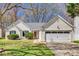 Charming single-story home featuring a well-manicured lawn, attached garage, and welcoming front entrance at 11000 White Stag Dr, Charlotte, NC 28269