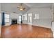 Spacious living room featuring hardwood floors, a fireplace, and vaulted ceilings, perfect for gatherings at 11000 White Stag Dr, Charlotte, NC 28269