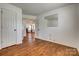 Bright room with hardwood flooring and French doors to living area with a fireplace at 11000 White Stag Dr, Charlotte, NC 28269