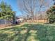 Large, lush backyard with mature trees and fencing, offering privacy and space at 11014 Fox Mill Ln, Charlotte, NC 28277