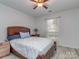 Bedroom featuring a ceiling fan, a wood frame bed, and neutral colored walls at 11014 Fox Mill Ln, Charlotte, NC 28277