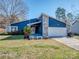 Charming blue home with stone accents, an American flag, and a cozy front bench at 11014 Fox Mill Ln, Charlotte, NC 28277