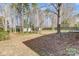 Large backyard with mature trees, two outbuildings and wooden fence at 1107 Franklin Thomas Pl, Charlotte, NC 28214