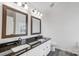 Bathroom featuring double sinks, black granite countertops, and white cabinetry at 1107 Franklin Thomas Pl, Charlotte, NC 28214