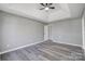 Bright bedroom featuring grey walls, luxury vinyl flooring and plenty of open space at 1107 Franklin Thomas Pl, Charlotte, NC 28214