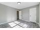 Neutral walls and vinyl plank flooring create a modern look in this cozy bedroom at 1107 Franklin Thomas Pl, Charlotte, NC 28214