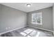 A light-filled bedroom features neutral walls and stylish vinyl plank flooring at 1107 Franklin Thomas Pl, Charlotte, NC 28214