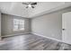 Large bedroom with tray ceiling, ceiling fan, and new floors, creating a calm space at 1107 Franklin Thomas Pl, Charlotte, NC 28214