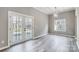 Dining room with backyard access through glass panel doors and a modern light fixture at 1107 Franklin Thomas Pl, Charlotte, NC 28214