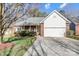 Charming single-story brick home featuring an attached two-car garage and manicured front lawn at 1107 Franklin Thomas Pl, Charlotte, NC 28214