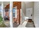 Covered front porch featuring brick columns, a welcome mat and chair on the entry way at 1107 Franklin Thomas Pl, Charlotte, NC 28214