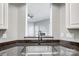 Kitchen sink view through to the living room with a fireplace at 1107 Franklin Thomas Pl, Charlotte, NC 28214