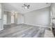 Spacious living room featuring wood-look flooring, ceiling fan, and fireplace with decorative mantle at 1107 Franklin Thomas Pl, Charlotte, NC 28214