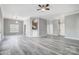 Spacious living room with neutral paint, modern ceiling fan and durable gray vinyl flooring at 1107 Franklin Thomas Pl, Charlotte, NC 28214