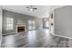 Spacious living room featuring wood-look floors, fireplace, and ample natural light at 1107 Franklin Thomas Pl, Charlotte, NC 28214