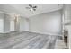 Expansive living room features neutral paint, modern trim, gray vinyl floors, and a fireplace at 1107 Franklin Thomas Pl, Charlotte, NC 28214