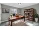 Cozy office space with a wooden desk, bookcase, and natural lighting at 1107 Franklin Thomas Pl, Charlotte, NC 28214