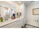 Bathroom featuring a double sink vanity, large mirror, and a glass-enclosed shower at 112 Abersham Dr, Mooresville, NC 28115