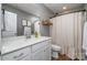 Bathroom with white vanity, large mirror, and a shower with a patterned curtain at 112 Abersham Dr, Mooresville, NC 28115