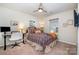 Bedroom with ceiling fan, computer desk, and a large window with blinds at 112 Abersham Dr, Mooresville, NC 28115