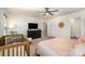 Large main bedroom with ceiling fan, large window, and a view of a bathroom and closet at 112 Abersham Dr, Mooresville, NC 28115