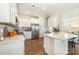 Modern kitchen with white cabinets, stainless steel appliances, and an island with bar seating at 112 Abersham Dr, Mooresville, NC 28115