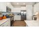 Well-equipped kitchen with stainless steel appliances, white cabinets, and stylish countertops at 112 Abersham Dr, Mooresville, NC 28115