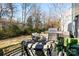 Outdoor patio with chairs, side table, potted plant, and a stainless steel grill at 11708 Huxley Rd, Charlotte, NC 28277