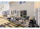 Outdoor patio with a grill and seating next to sliding glass doors, overlooking the backyard at 11708 Huxley Rd, Charlotte, NC 28277