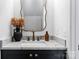 Stylish powder room boasting a marble countertop, decorative mirror, and bronze faucet at 11708 Huxley Rd, Charlotte, NC 28277