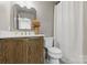 Bright bathroom showcasing a vanity with a quartz countertop, gold fixtures, and a convenient toilet at 11708 Huxley Rd, Charlotte, NC 28277