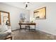 Inviting room featuring neutral color palette, contemporary artwork and well-lit workspace at 11708 Huxley Rd, Charlotte, NC 28277