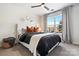 Bright bedroom featuring a large window, ceiling fan, and neutral decor at 11708 Huxley Rd, Charlotte, NC 28277