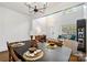 Dining room with an open floor plan, views of a living room, and a modern chandelier at 11708 Huxley Rd, Charlotte, NC 28277