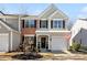 Charming two-story home featuring black shutters, an attached garage, and an inviting front entrance at 11708 Huxley Rd, Charlotte, NC 28277