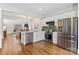 Beautiful kitchen featuring stainless steel appliances, white cabinets, and hardwood flooring at 11708 Huxley Rd, Charlotte, NC 28277