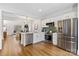 Modern kitchen features stainless steel appliances, granite counters, and hardwood floors at 11708 Huxley Rd, Charlotte, NC 28277