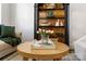 Close up of a living room showing stylish decor and a round wooden coffee table at 11708 Huxley Rd, Charlotte, NC 28277