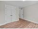 Minimalist bedroom with ample closet space and wood-look flooring at 130A Springway Dr, Kannapolis, NC 28081