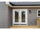 Close-up of glass doors leading to the outdoor deck of a house with gray siding at 130A Springway Dr, Kannapolis, NC 28081