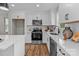 Modern kitchen featuring white cabinets, stainless steel appliances, and sleek countertops at 130A Springway Dr, Kannapolis, NC 28081