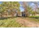 View of a backyard with some foliage and shed, partially obscured by trees at 133 Sutton S Rd, Fort Mill, SC 29708