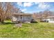 View of a charming home with a welcoming front porch, surrounded by a well-kept lawn, and a carport at 133 Sutton S Rd, Fort Mill, SC 29708