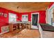 Interior shot of the kitchen featuring bright red walls and outdated fixtures at 133 Sutton S Rd, Fort Mill, SC 29708