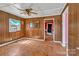 Living room with wood paneling and view into hallway featuring pink paint at 133 Sutton S Rd, Fort Mill, SC 29708