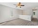 Upstairs bonus room features a ceiling fan, neutral walls and carpet, and a window at 13923 Singleleaf Ln, Charlotte, NC 28278