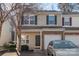 Charming townhome featuring a brick-accented facade, attached garage, and manicured landscaping at 13923 Singleleaf Ln, Charlotte, NC 28278