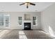 Bright living room showcasing a fireplace, large windows, and access to the backyard at 13923 Singleleaf Ln, Charlotte, NC 28278