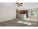 Open living room, carpeted, featuring kitchen, fireplace and backyard access at 13923 Singleleaf Ln, Charlotte, NC 28278